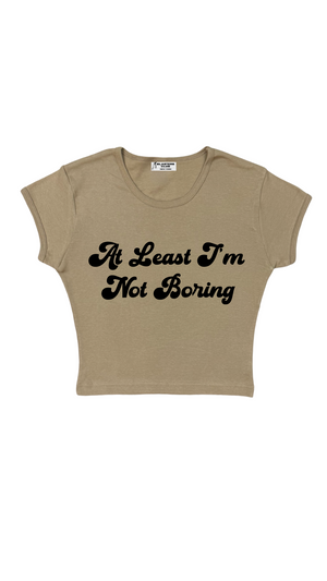 At Least I'm Not Boring Crop Baby Tee in Hazlenut