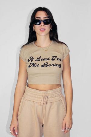 At Least I'm Not Boring Crop Baby Tee in Hazlenut