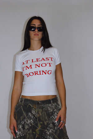 At Least I'm Not Boring Baby Tee